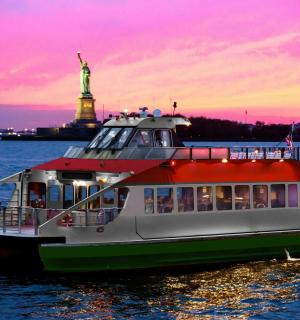 a boat in the water with the statue of liberty