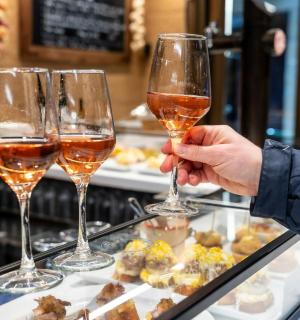 a person holding up two glasses of wine