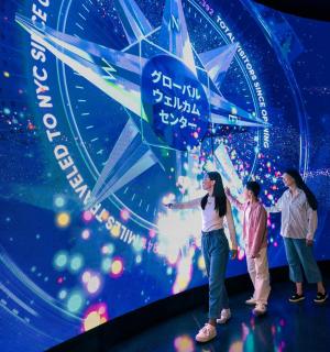 a group of people standing in front of a screen