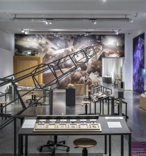a museum exhibit with a staircase and a mural