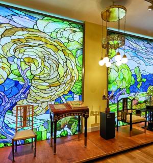 a large stained glass mural in a room with tables and chairs