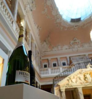 a bottle of wine sitting on a box in a room