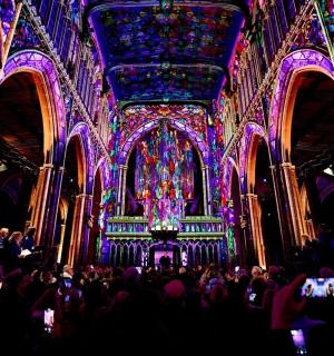 Eine Gruppe von Menschen in einem großen Raum mit violettem Licht