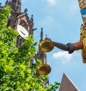 a street light in front of a clock tower