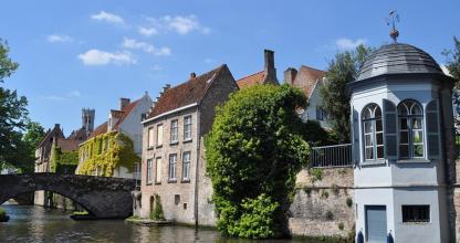 a building in the water next to a bridge