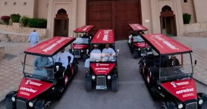 a group of golf carts parked in front of a building