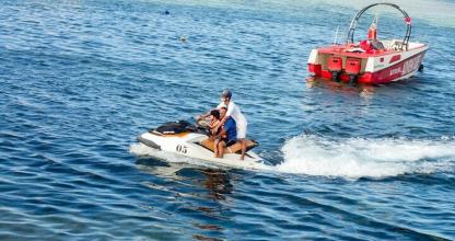 a man and a woman on a boat in the water