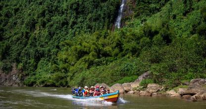un grup de persones en una barca en un riu