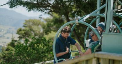 a group of men riding a roller coaster