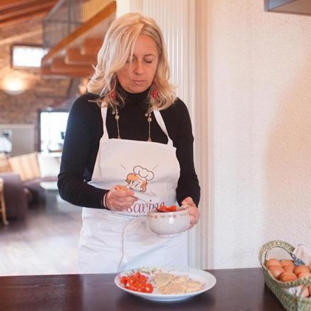 a woman in a kitchen holding a bowl of food
