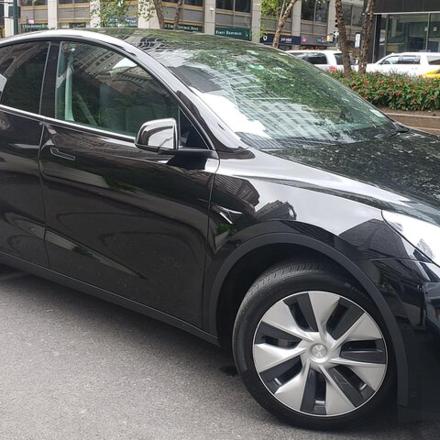 a black car parked on the side of a street