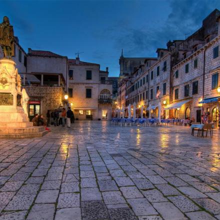 a city square with a statue in the middle
