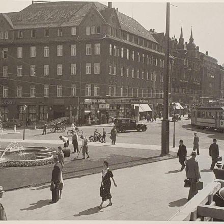 ein Schwarzweißfoto von Menschen, die in einer Stadt spazieren gehen