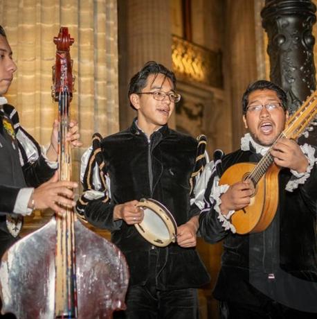 a group of men playing music and playing instruments