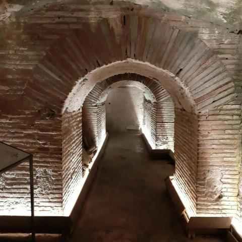 an empty hallway in an old brick building