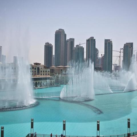 a group of fountains in the water in a city