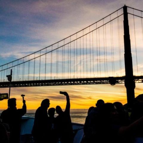 un grup de oameni care stau în fața unui pod