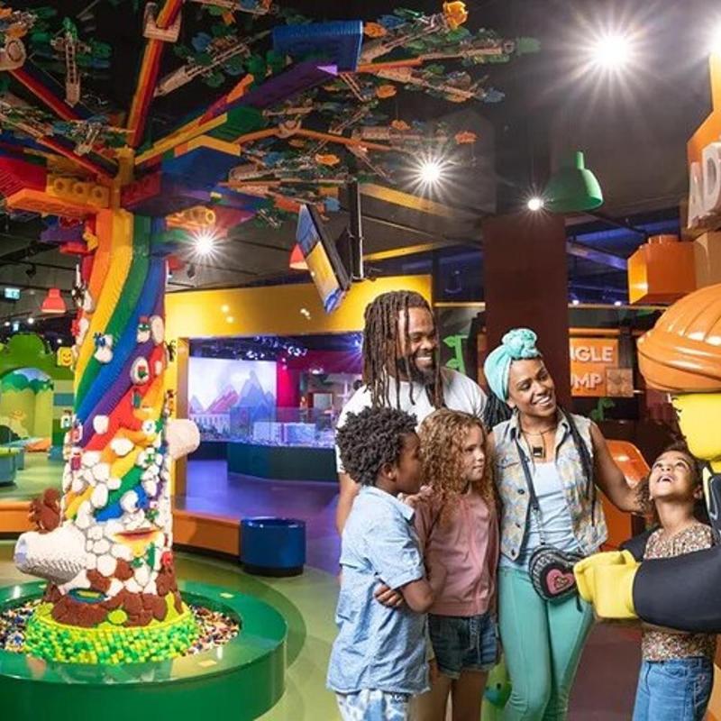 a group of people standing in front of a play center