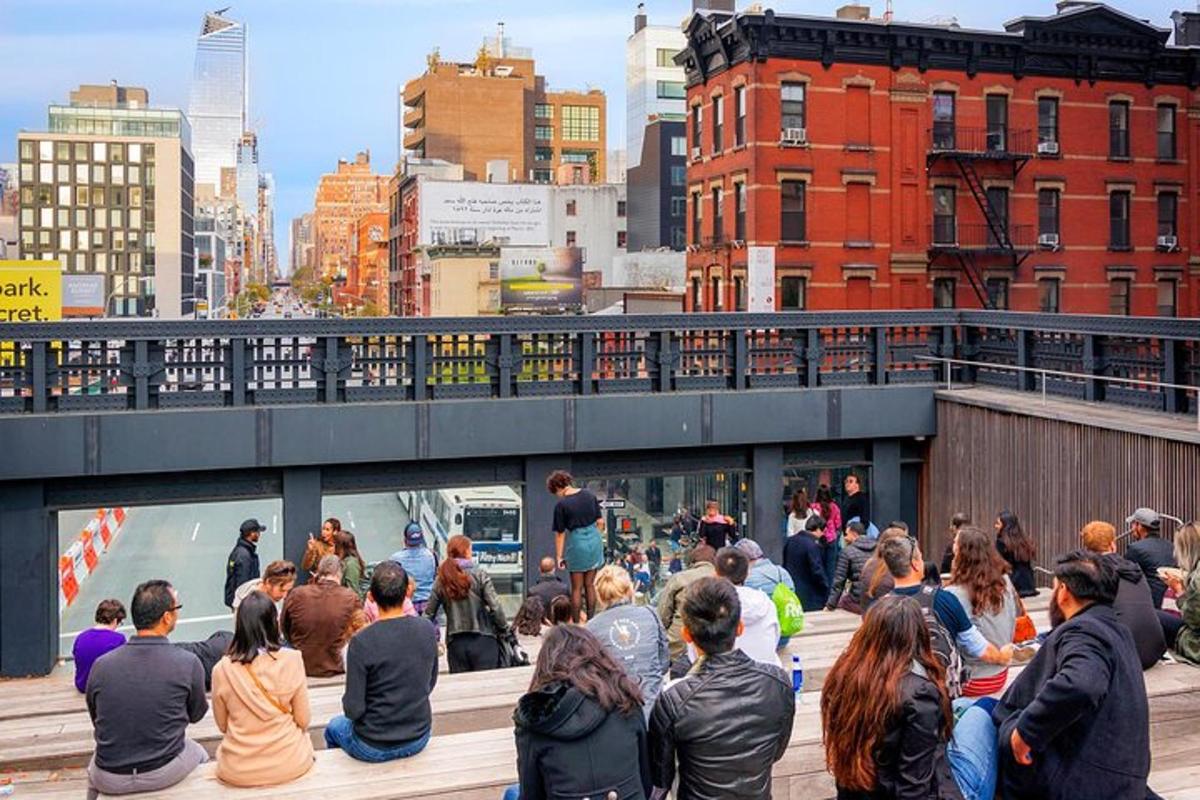 a crowd of people sitting on a bridge in a city