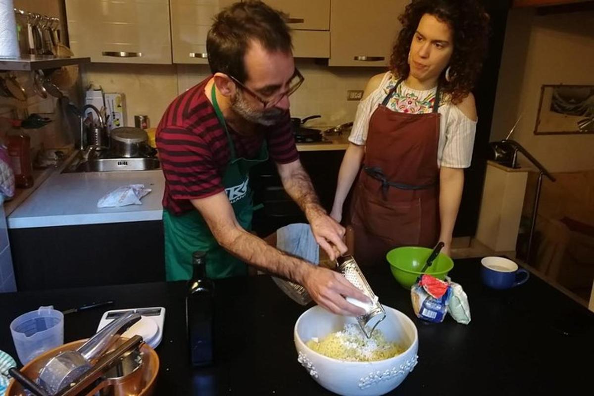 a man and woman in a kitchen mixing food in a bowl