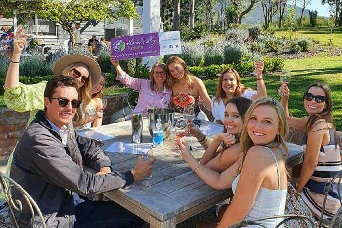 a group of people sitting around a wooden table