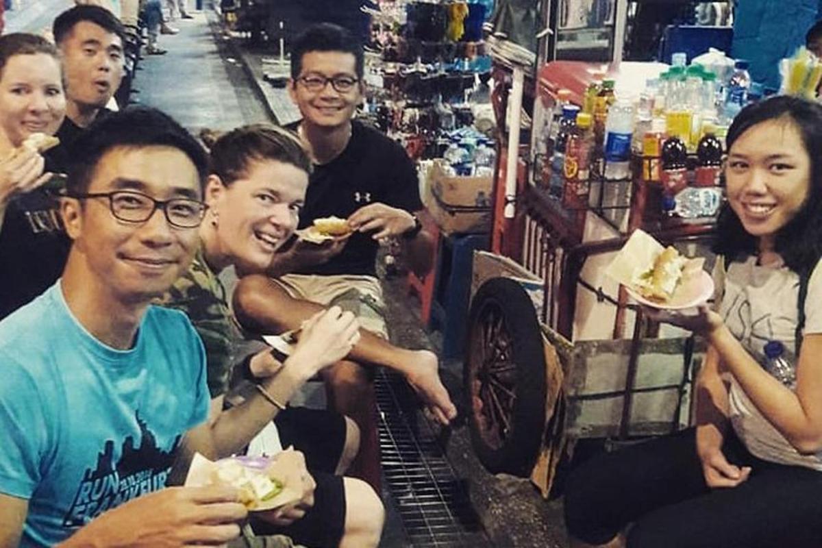 a group of people eating food in a store