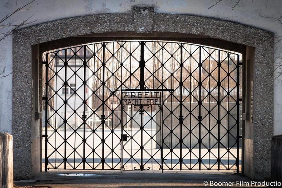 an iron gate with a basketball hoop behind it