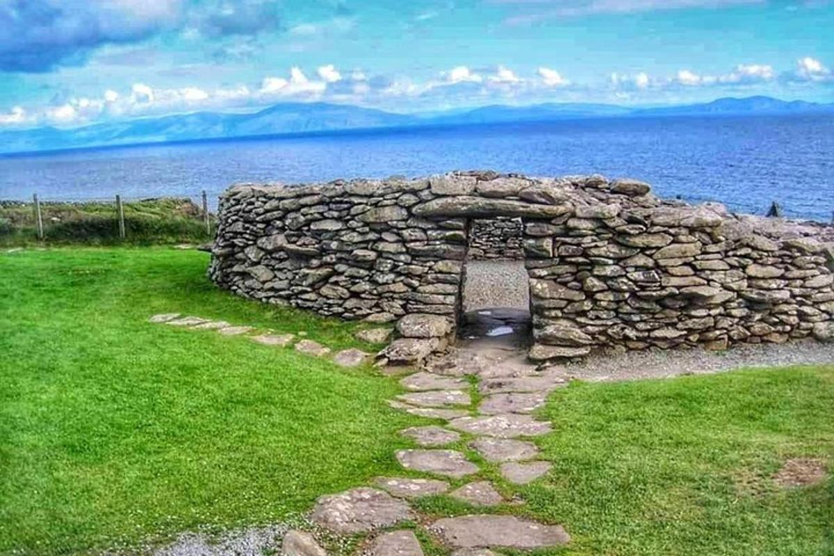 an old stone wall next to a body of water