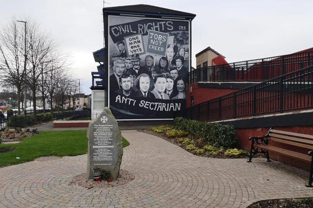 a sign in front of a building with a mural