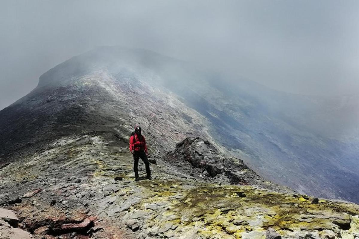 a person standing on the top of a mountain