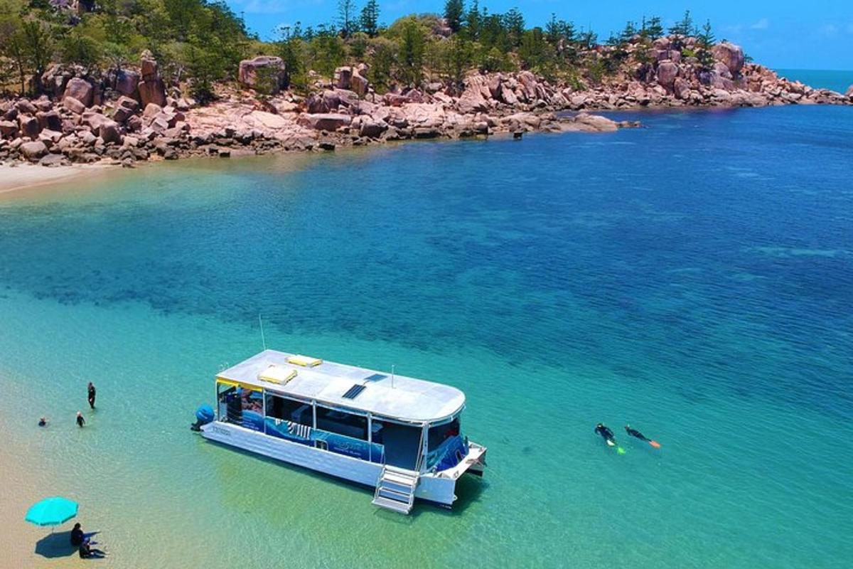 a blue boat in the water at a beach
