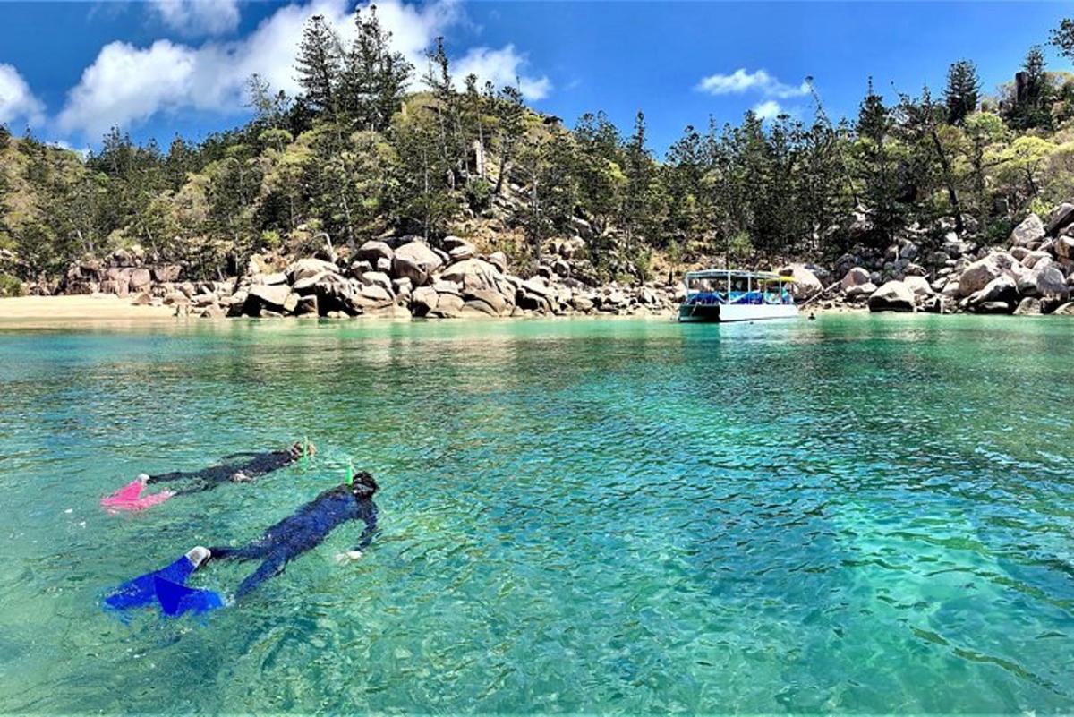 two people swimming in a body of water