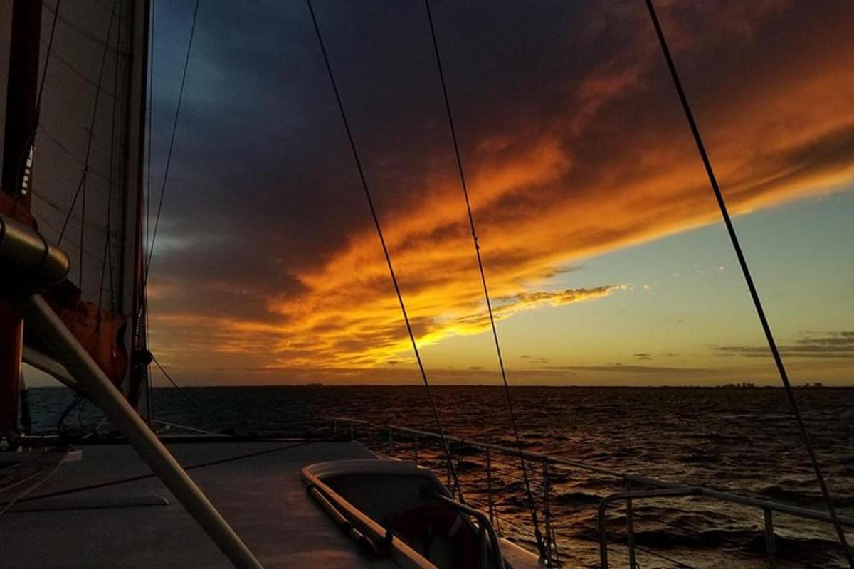 a sunset on a boat in the ocean
