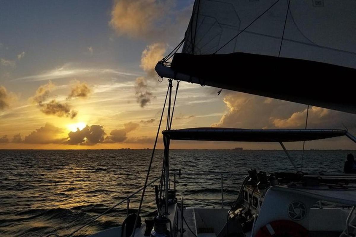 a boat in the ocean with a sunset