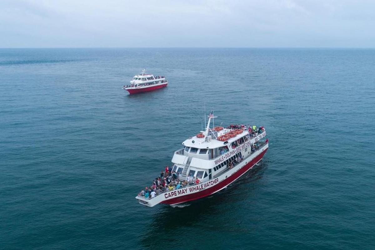 two boats in the water with people on them