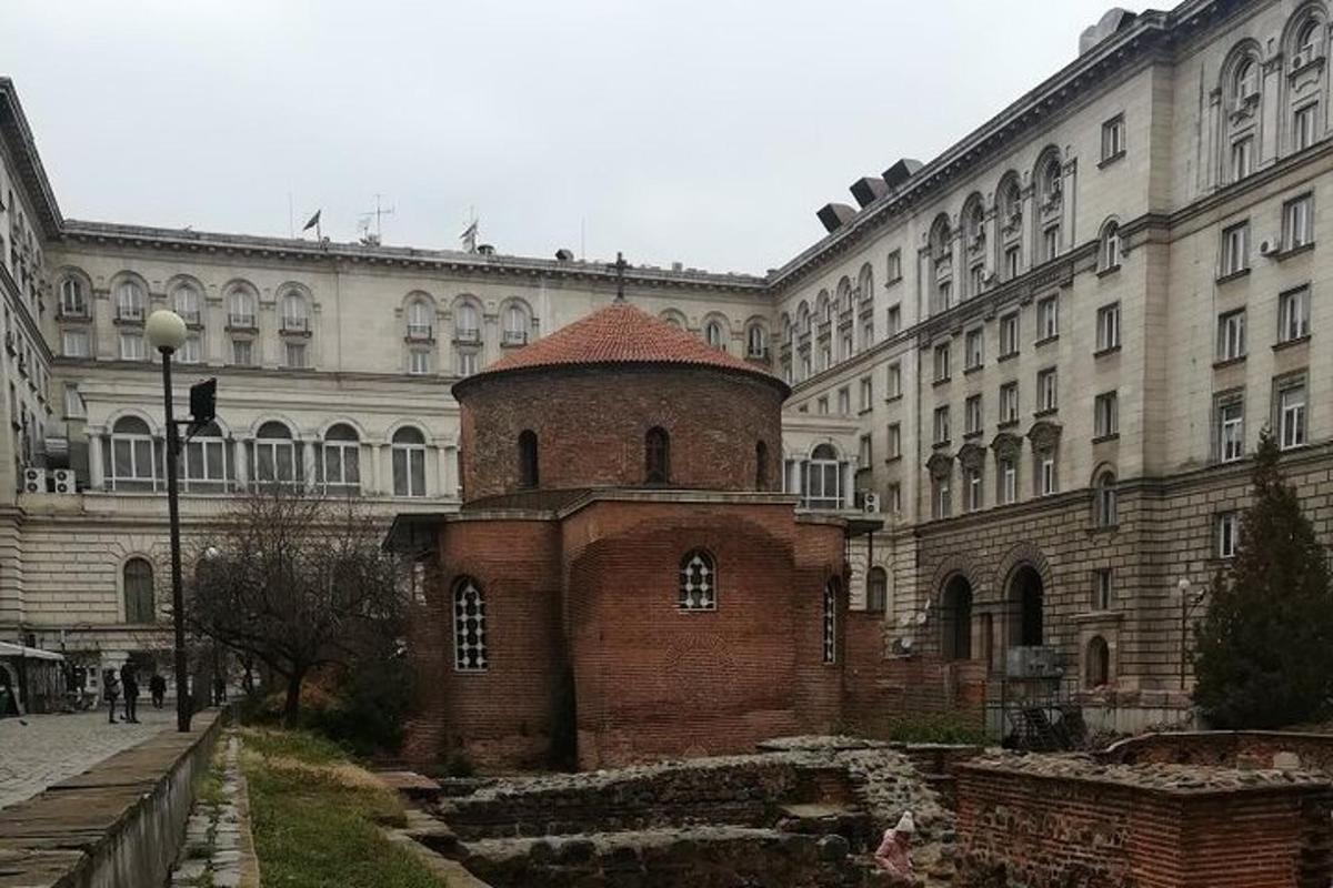 a large building with a brick tower in front of it
