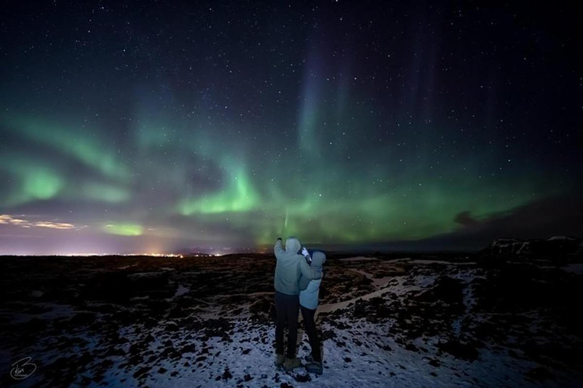 una persona che guarda l'aurora boreale nel cielo