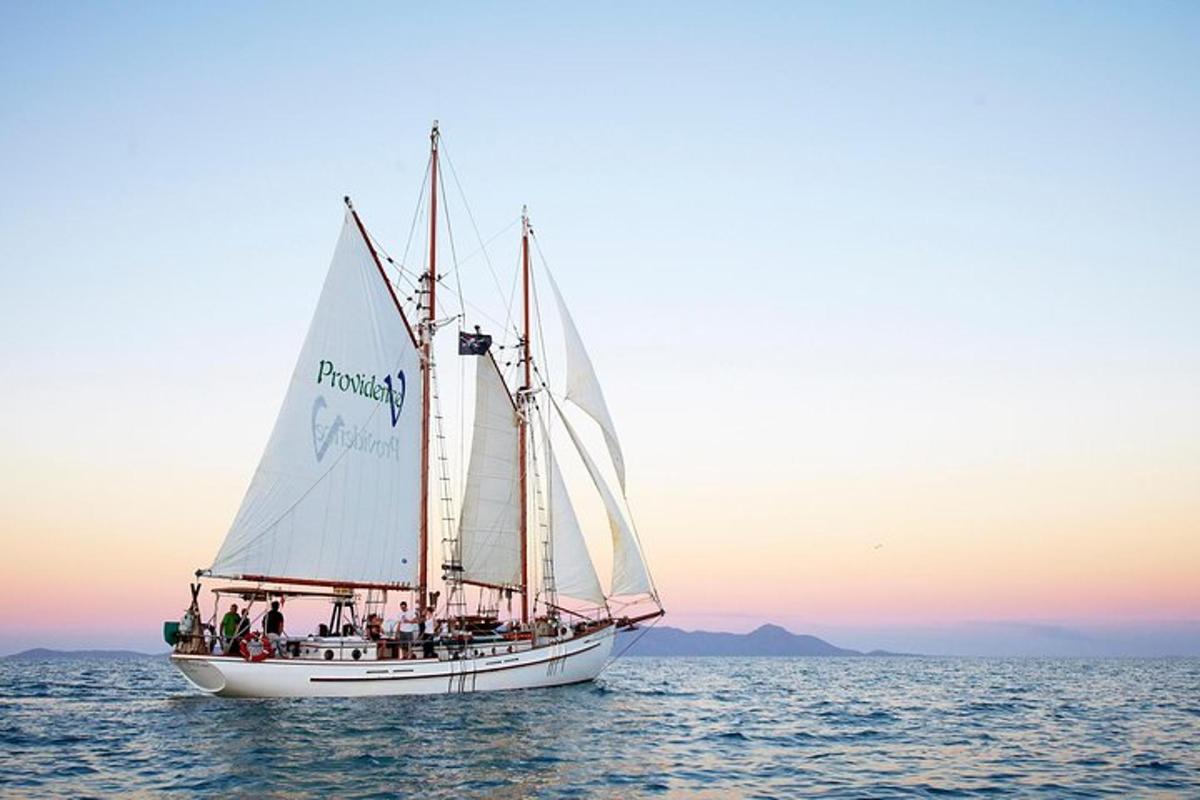 a group of people on a sail boat in the water
