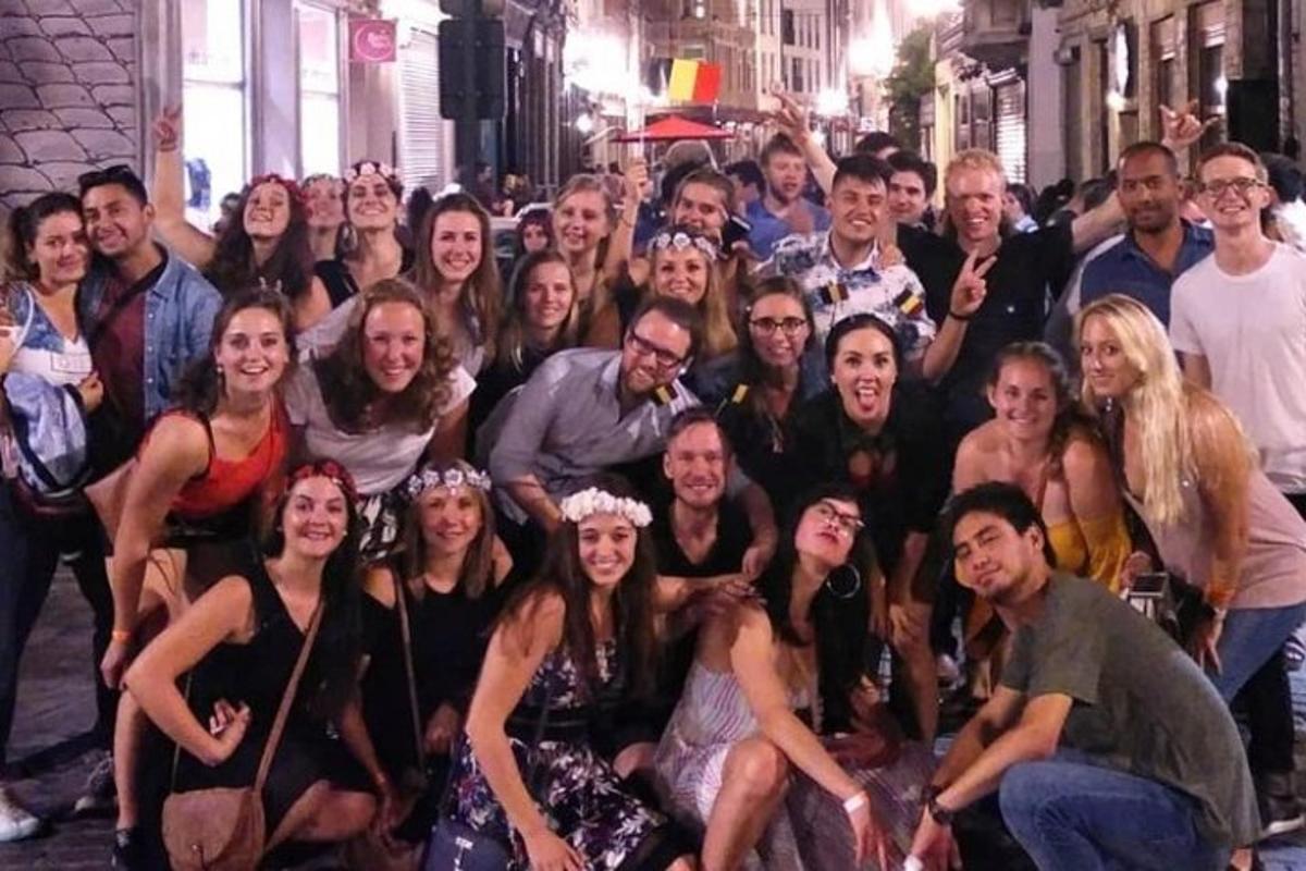 a group of people posing for a picture on a street