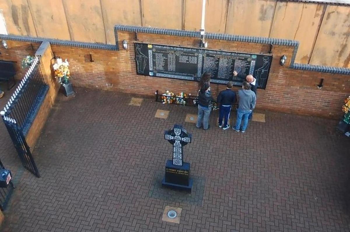a group of people standing in front of a cross