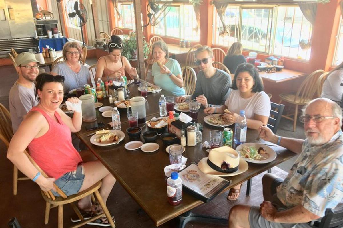 a group of people sitting at a table eating food