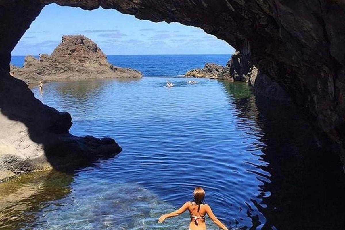 a woman in the water in a cave