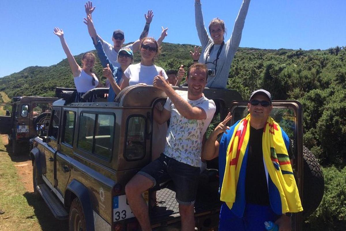 a group of people are riding in a jeep