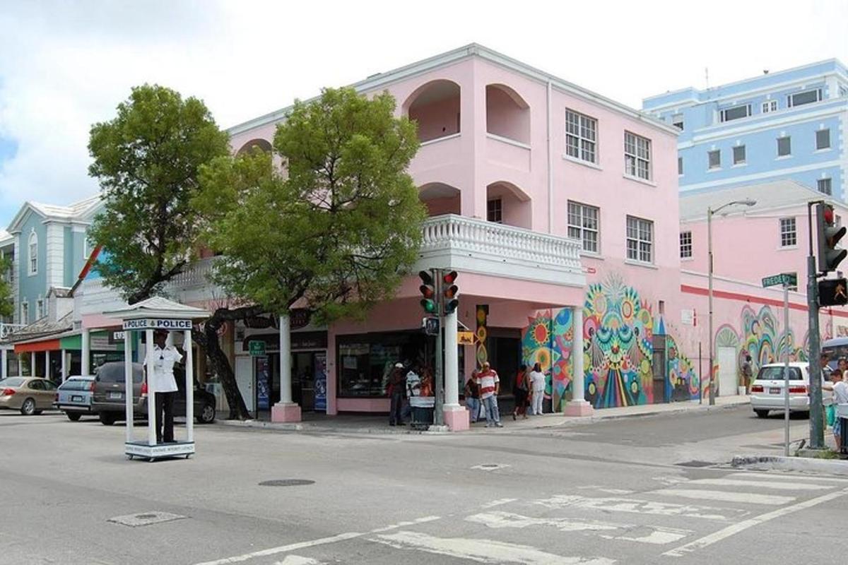 a pink building on the corner of a street