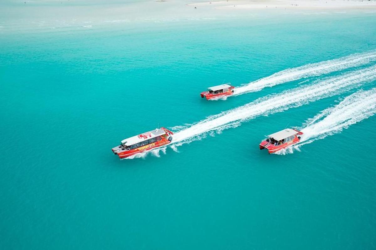 three boats are in the water in the ocean