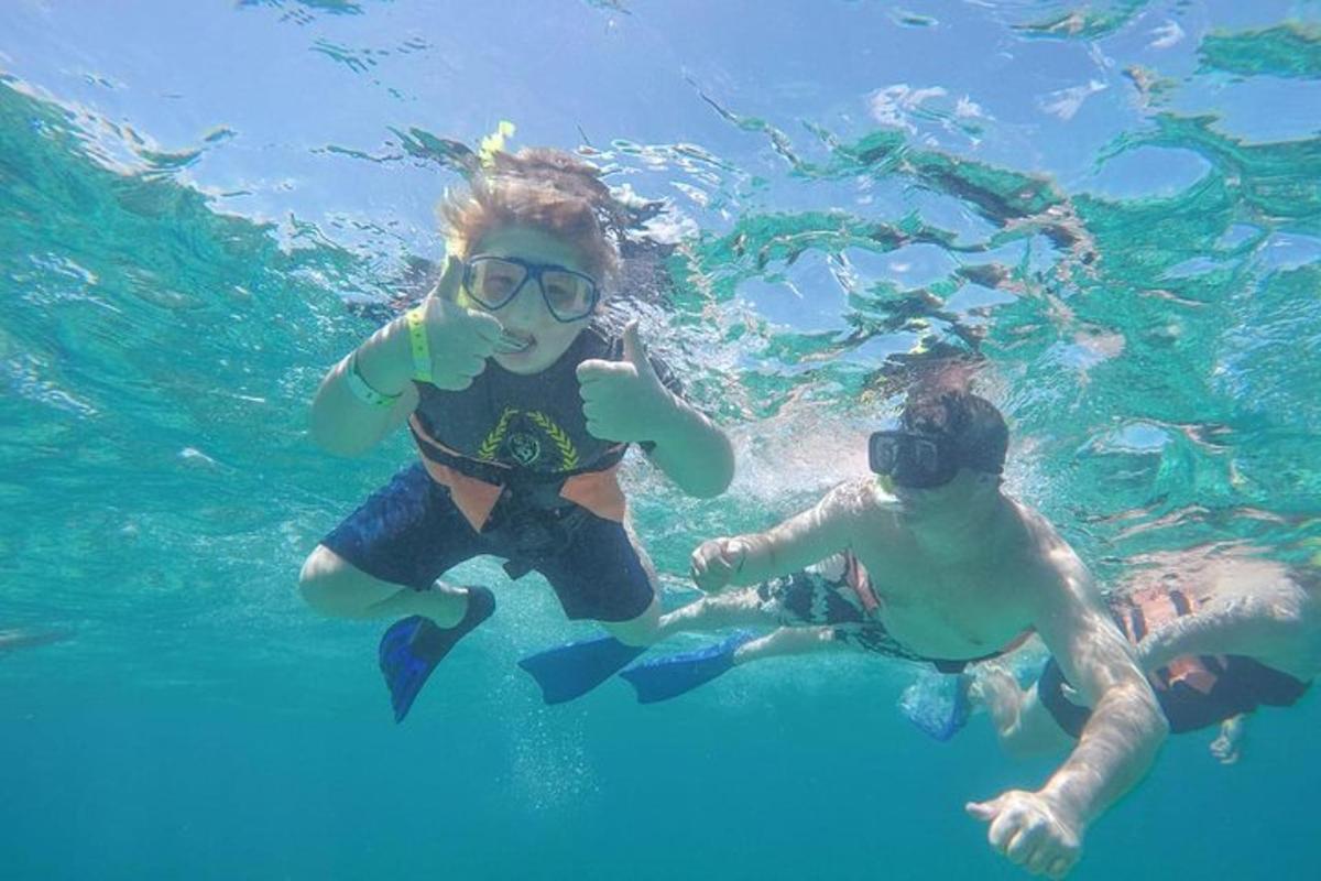 two children are swimming in the blue water