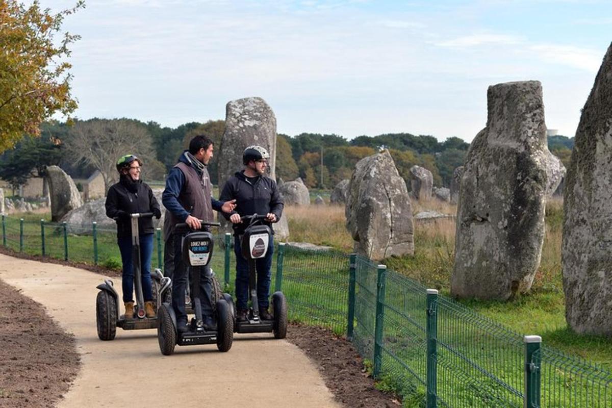 three people riding segways on a path at a cemetery