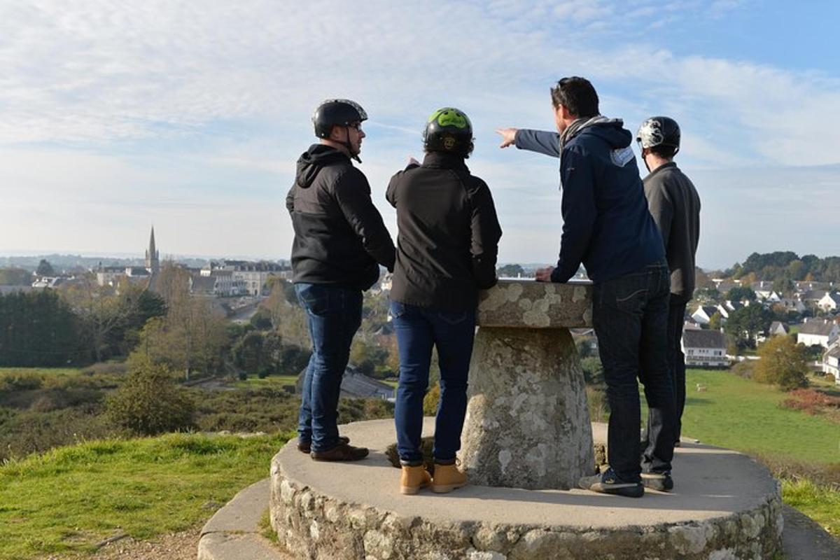 a group of people standing on top of a stone ledge