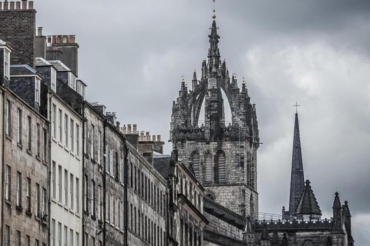 an old building with a tower and a steeple in a city