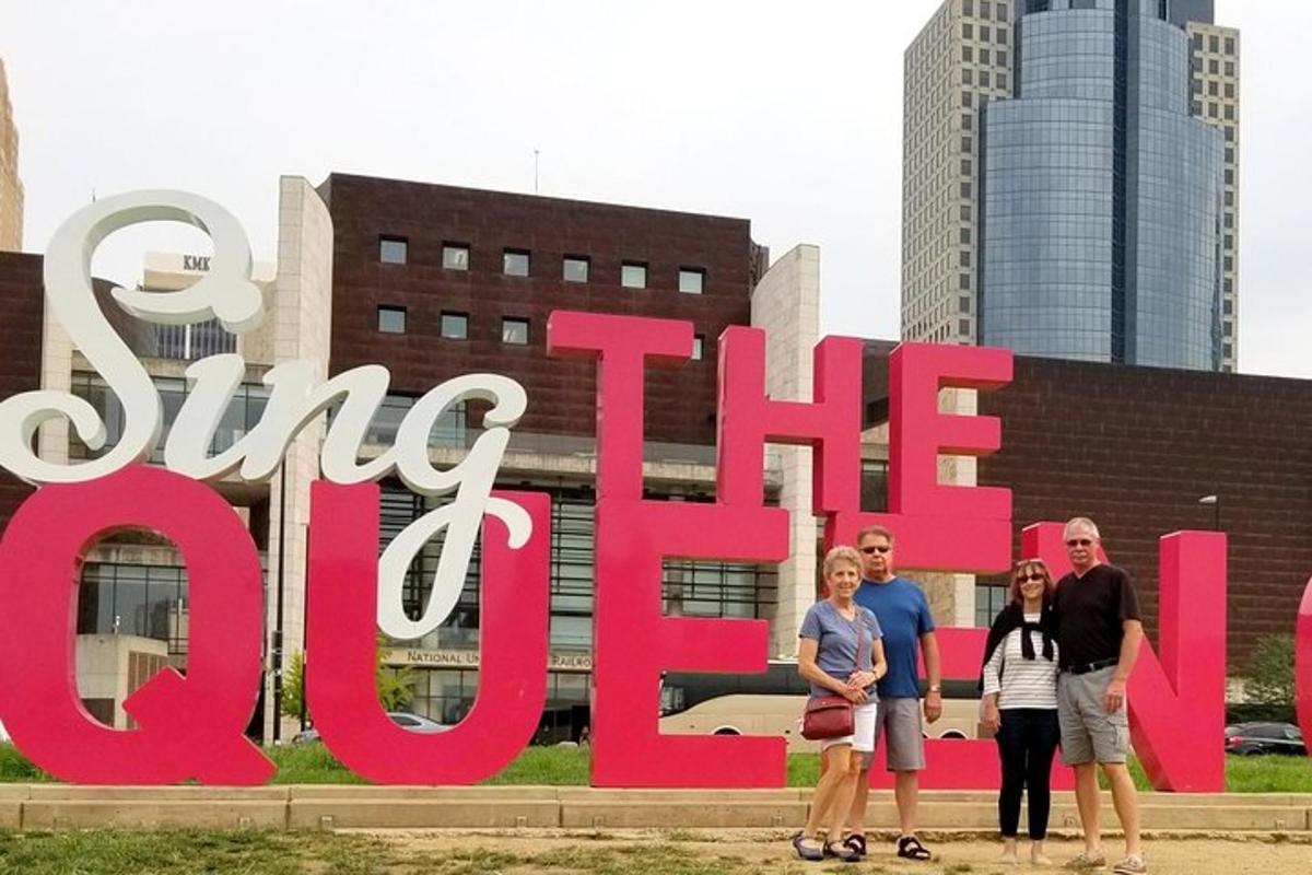 a group of people standing in front of a big sign